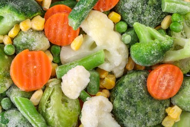 Photo of Mix of different frozen vegetables as background, top view