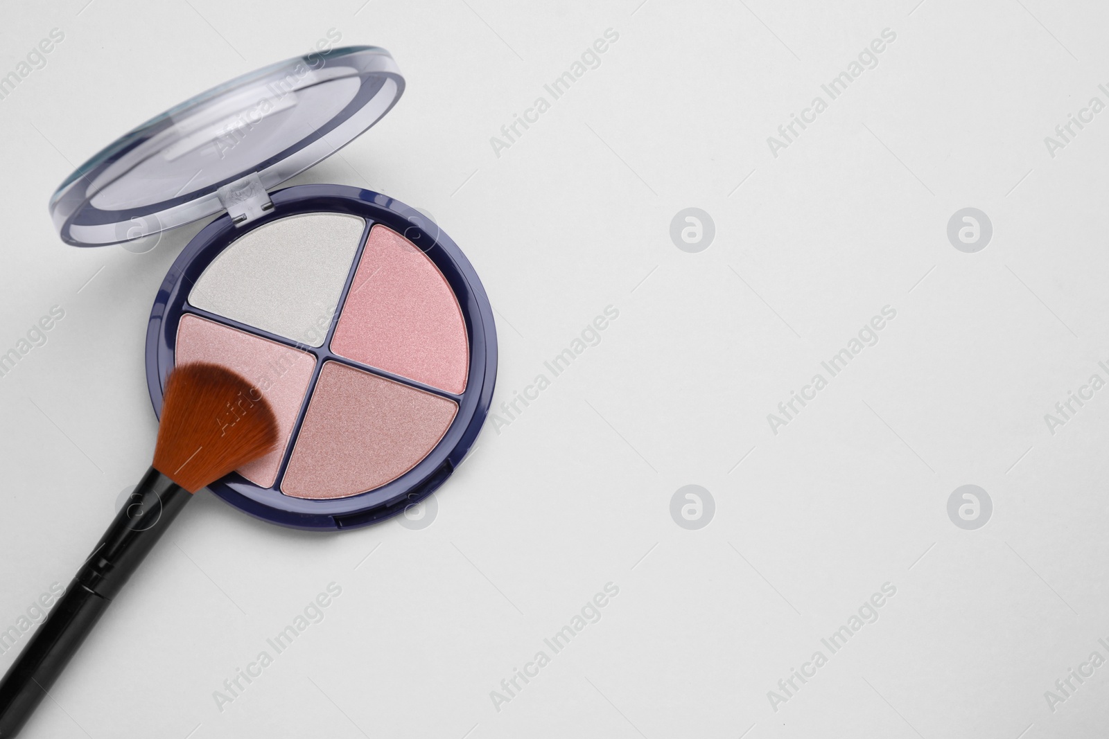 Photo of Colorful contouring palette and brush on light grey background, top view with space for text. Professional cosmetic product