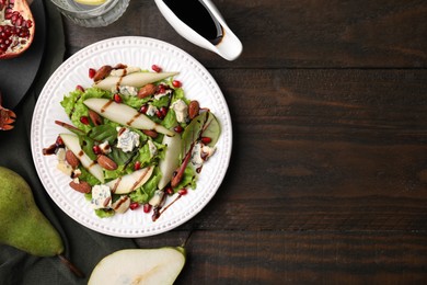 Photo of Delicious pear salad with sauce on wooden table, flat lay. Space for text