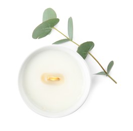 Photo of Beautiful candle with wooden wick and eucalyptus on white background, top view