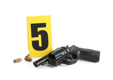 Photo of Gun, bullets and crime scene marker with number five isolated on white