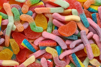Photo of Many different tasty jelly candies as background, top view