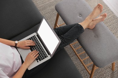 Photo of Woman with laptop on sofa at home, closeup