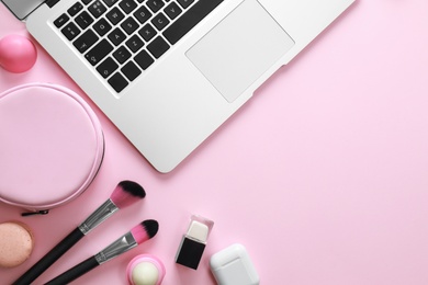 Flat lay composition with laptop on pink background. Beauty blogger's workplace