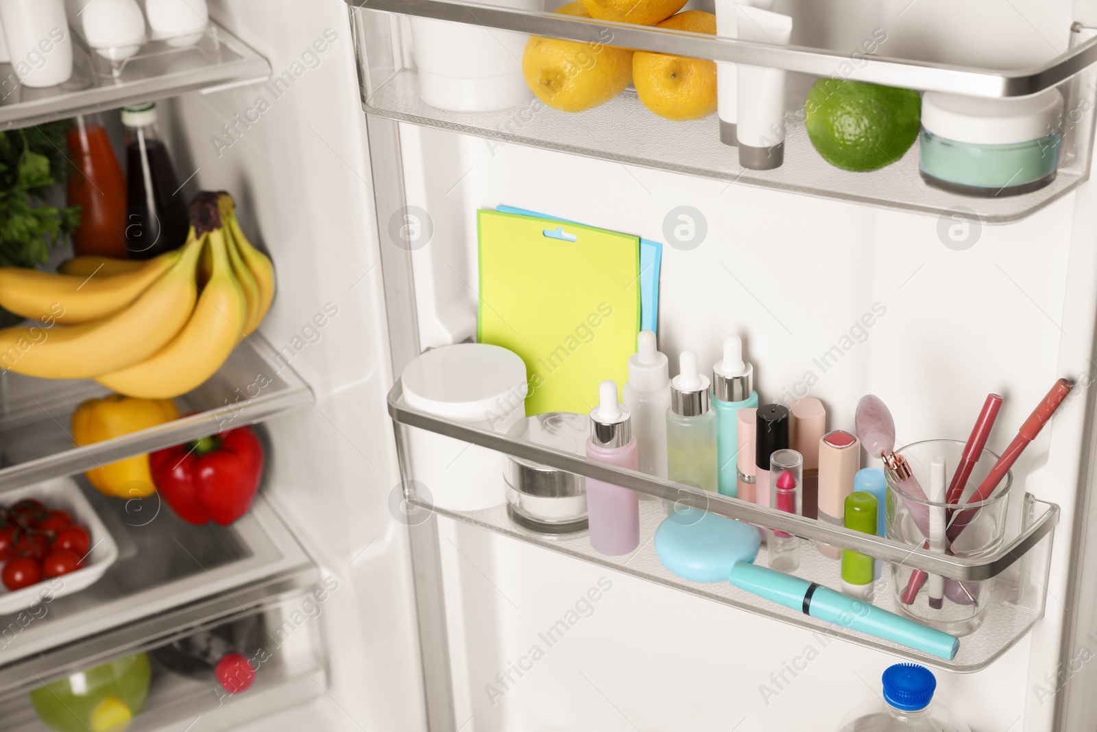 Photo of Storage of cosmetics and tools in refrigerator door bins next to groceries