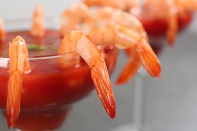 Photo of Delicious shrimp cocktail with tomato sauce, closeup