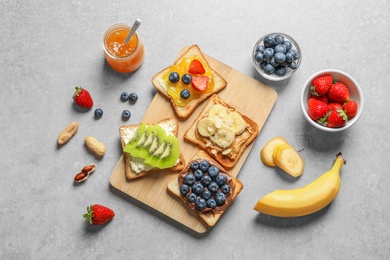 Flat lay composition with toast bread and different toppings on grey background