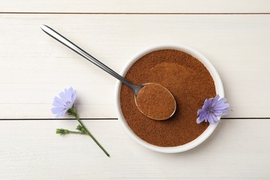 Bowl of chicory powder and flowers on white wooden table, flat lay
