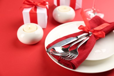 Photo of Beautiful table setting for Valentine's Day on red background