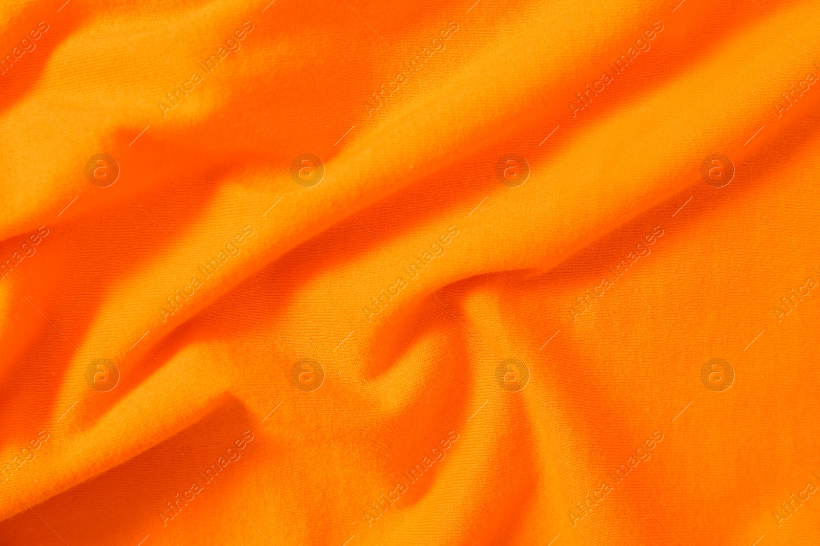 Photo of Texture of orange fabric as background, top view