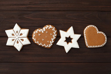 Different delicious Christmas cookies on wooden table, flat lay