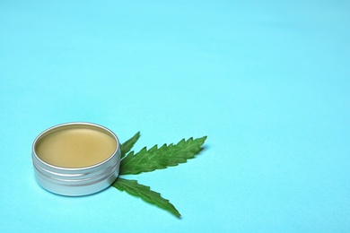 Photo of Jar with hemp lotion and space for text on color background