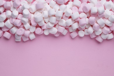 Photo of Delicious marshmallows on pink background, flat lay. Space for text