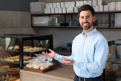 Portrait of happy business owner in bakery shop