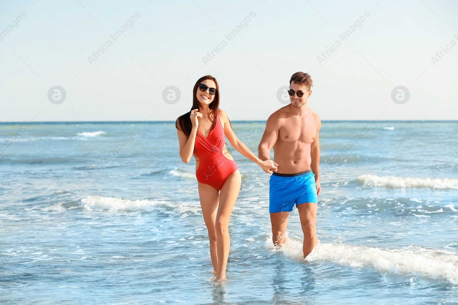 Photo of Happy young couple having fun at beach on sunny day