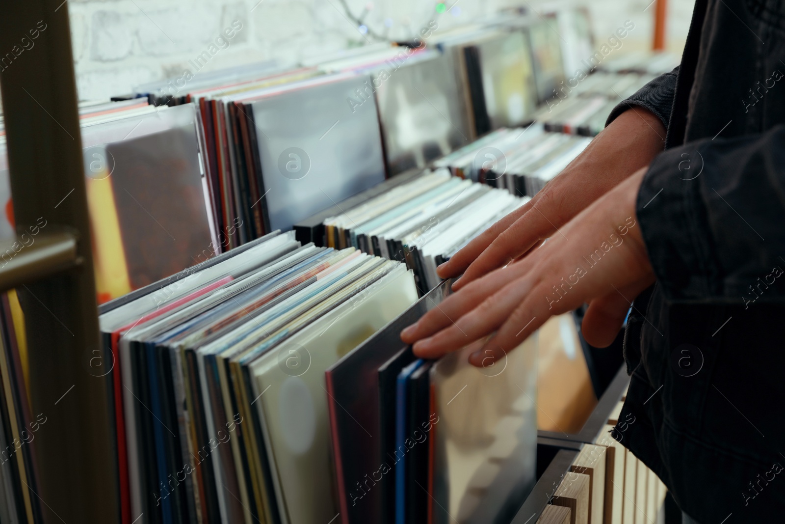 Image of Man choosing vinyl records in store, closeup