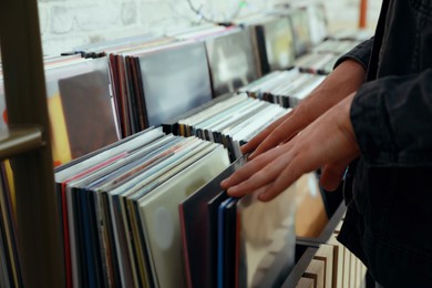 Man choosing vinyl records in store, closeup