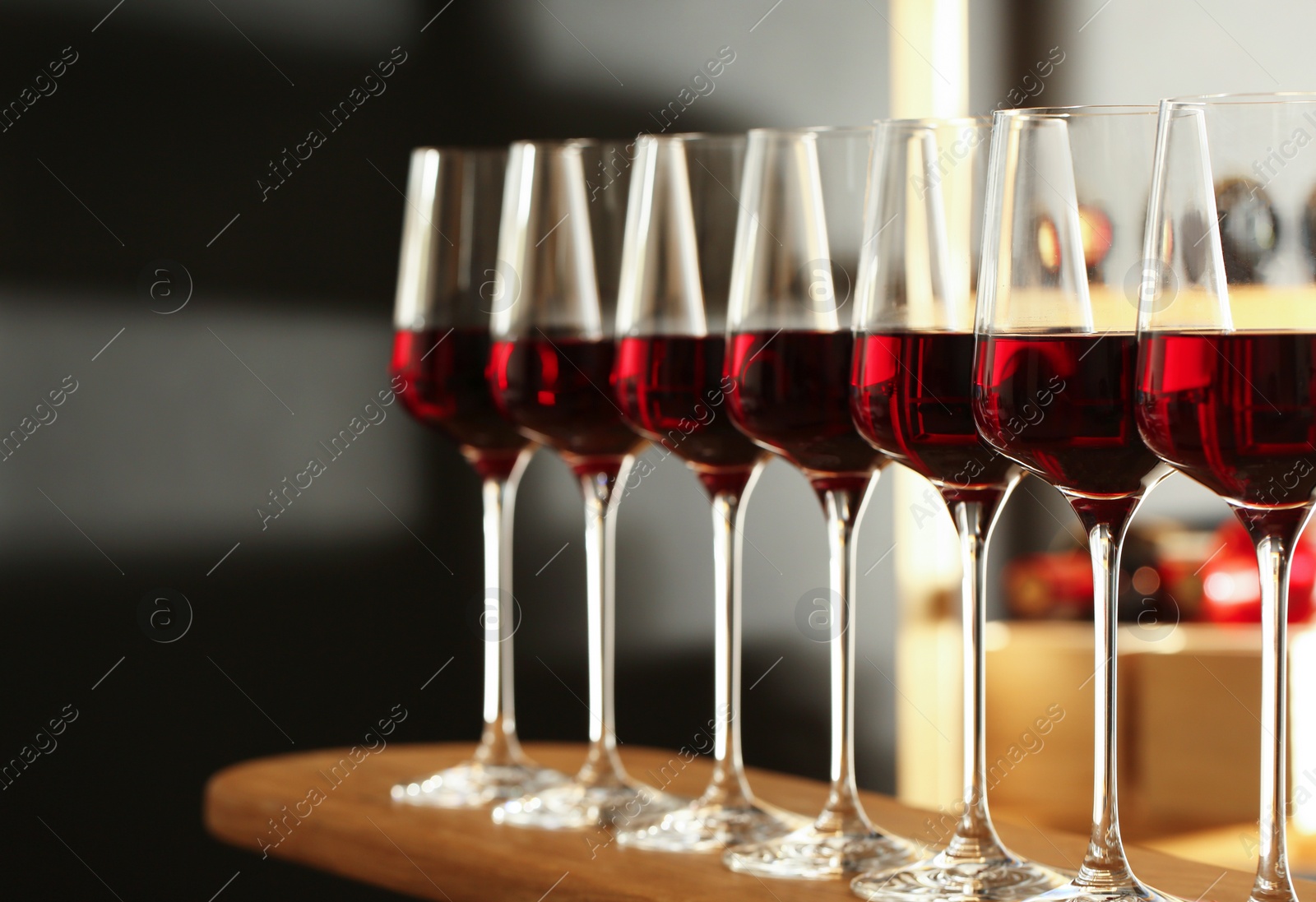 Photo of Glasses of red wine in cellar. Expensive drink