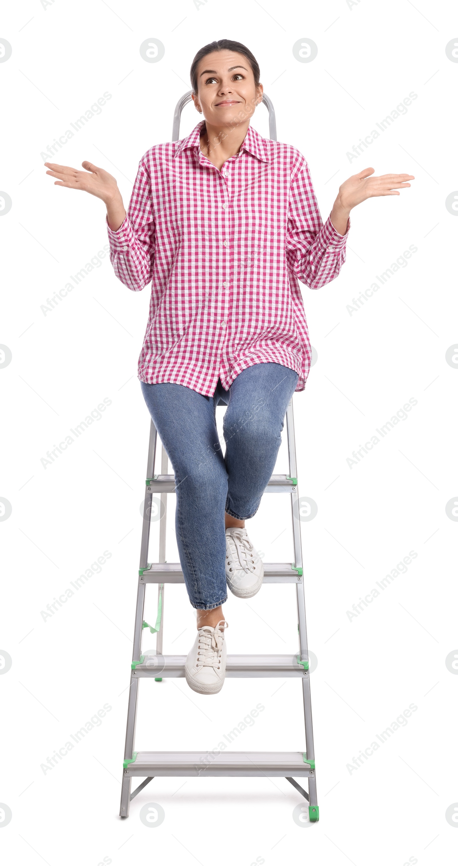 Photo of Young woman sitting on metal ladder against white background