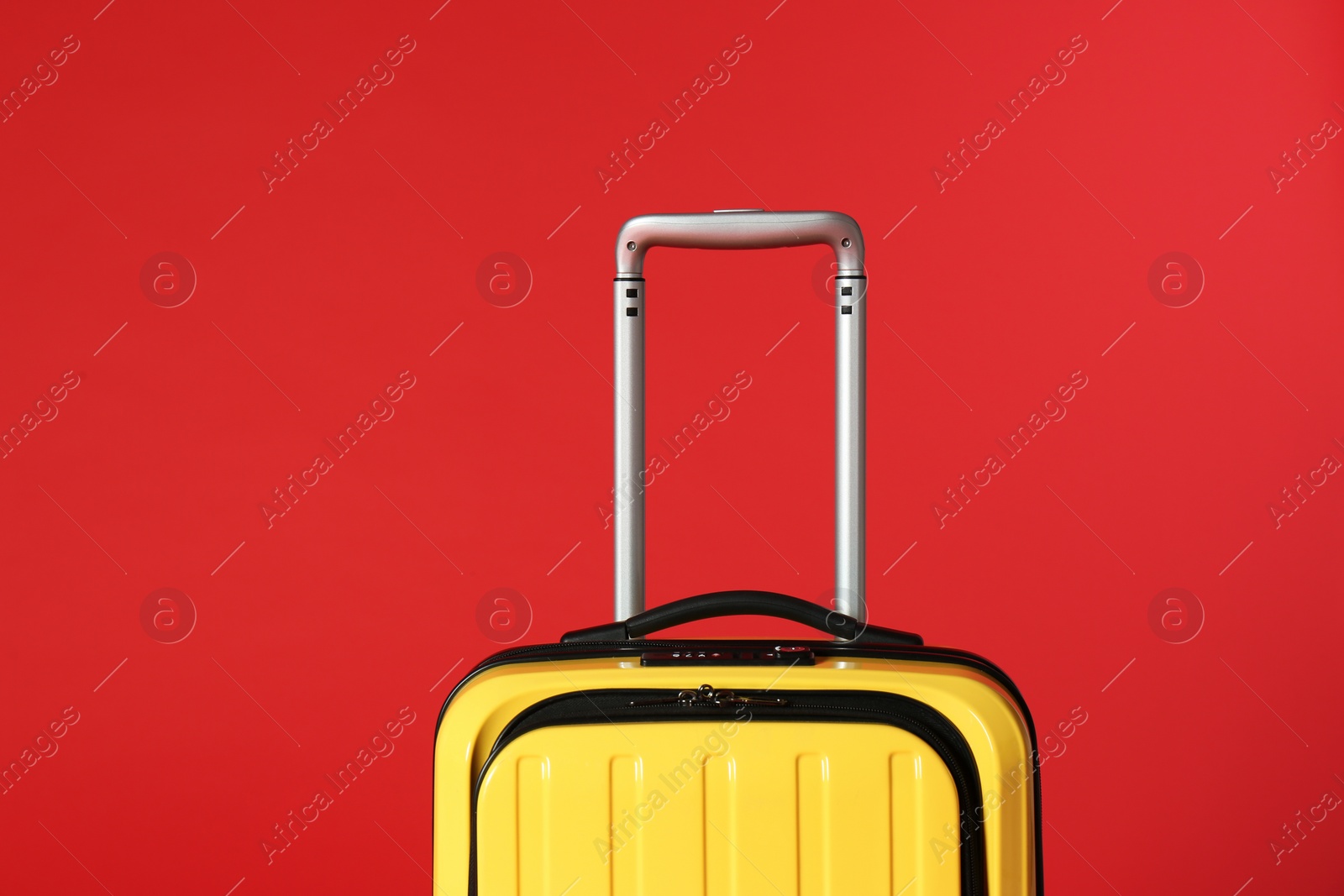 Photo of Stylish yellow suitcase with handle on color background