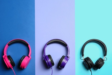 Stylish headphones on color background, flat lay. Space for text