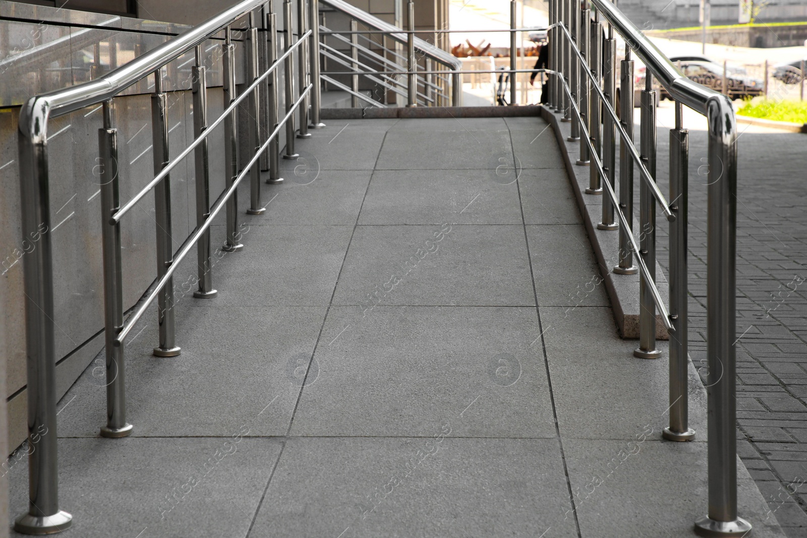 Photo of Ramp with metal handrails near building outdoors