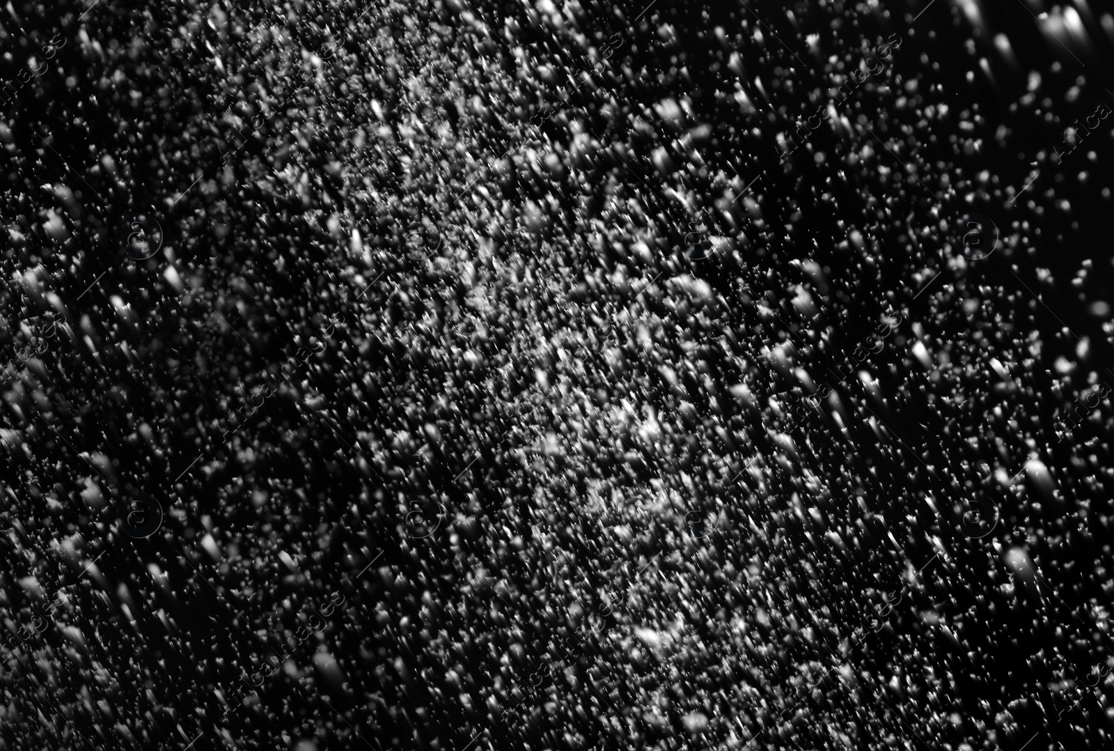 Photo of Snow flakes falling on black background. Winter weather