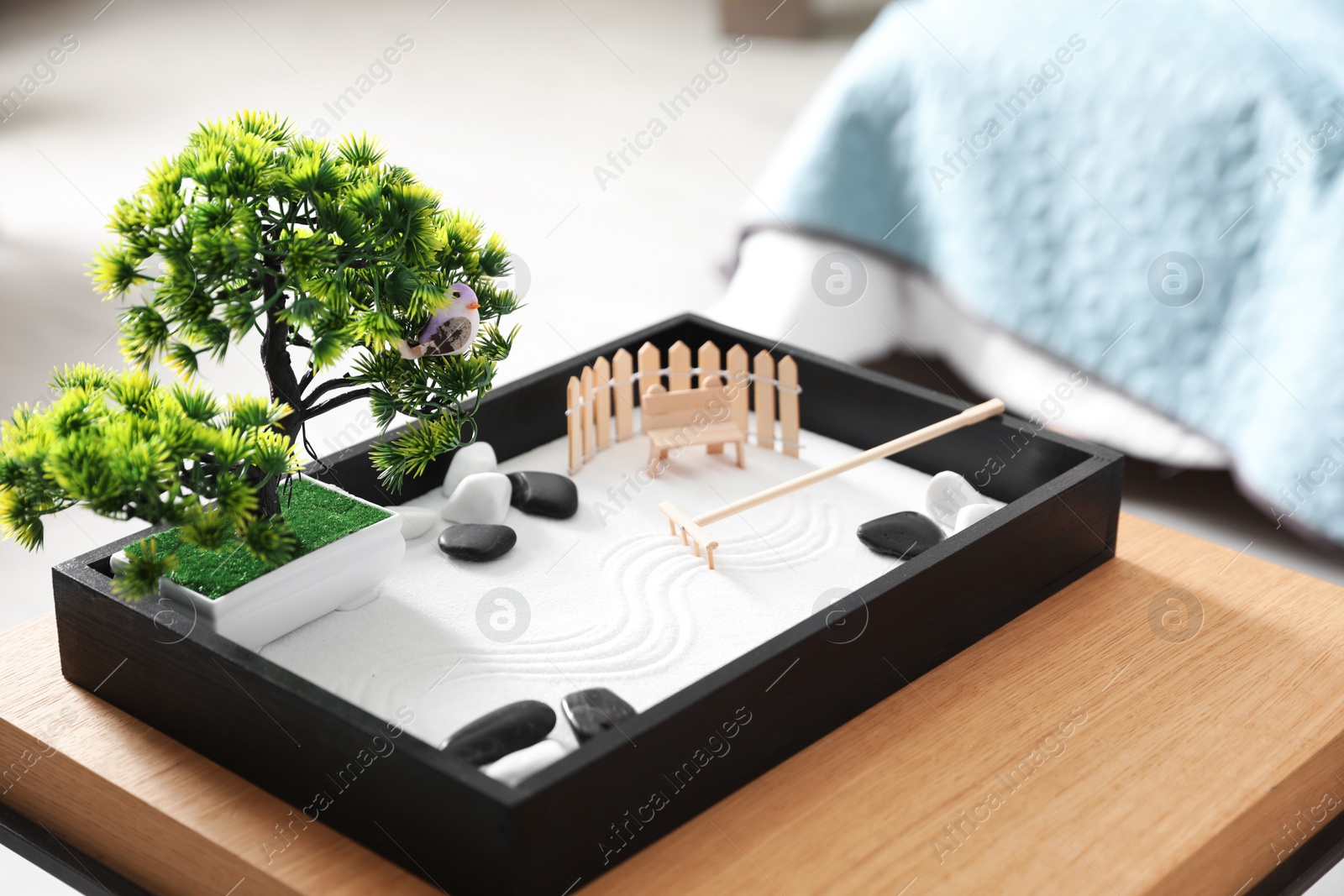 Photo of Beautiful miniature zen garden on wooden table indoors