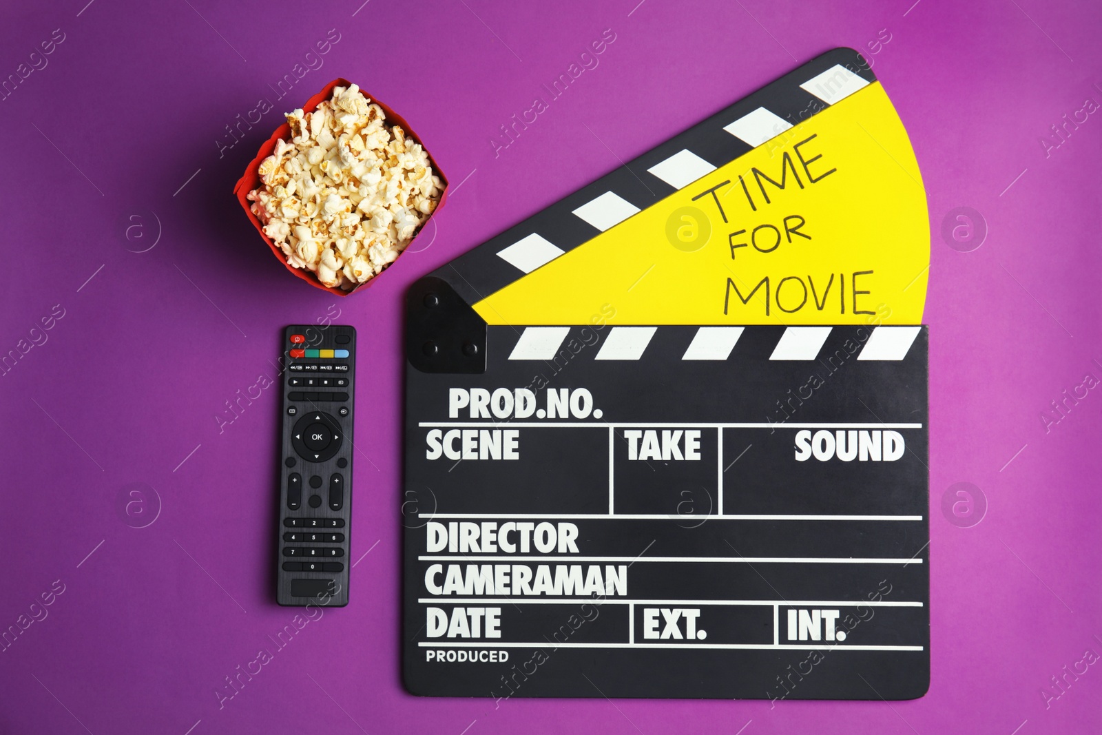 Photo of Flat lay composition with popcorn, cinema clapperboard and TV remote on color background