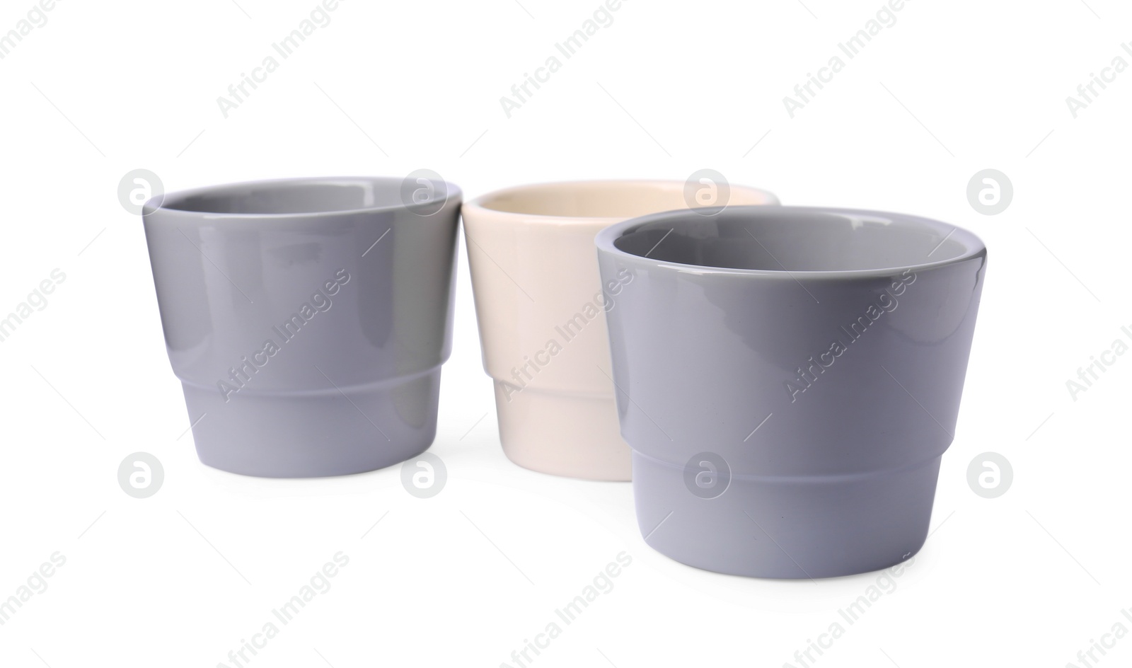 Photo of Different empty ceramic flower pots on white background