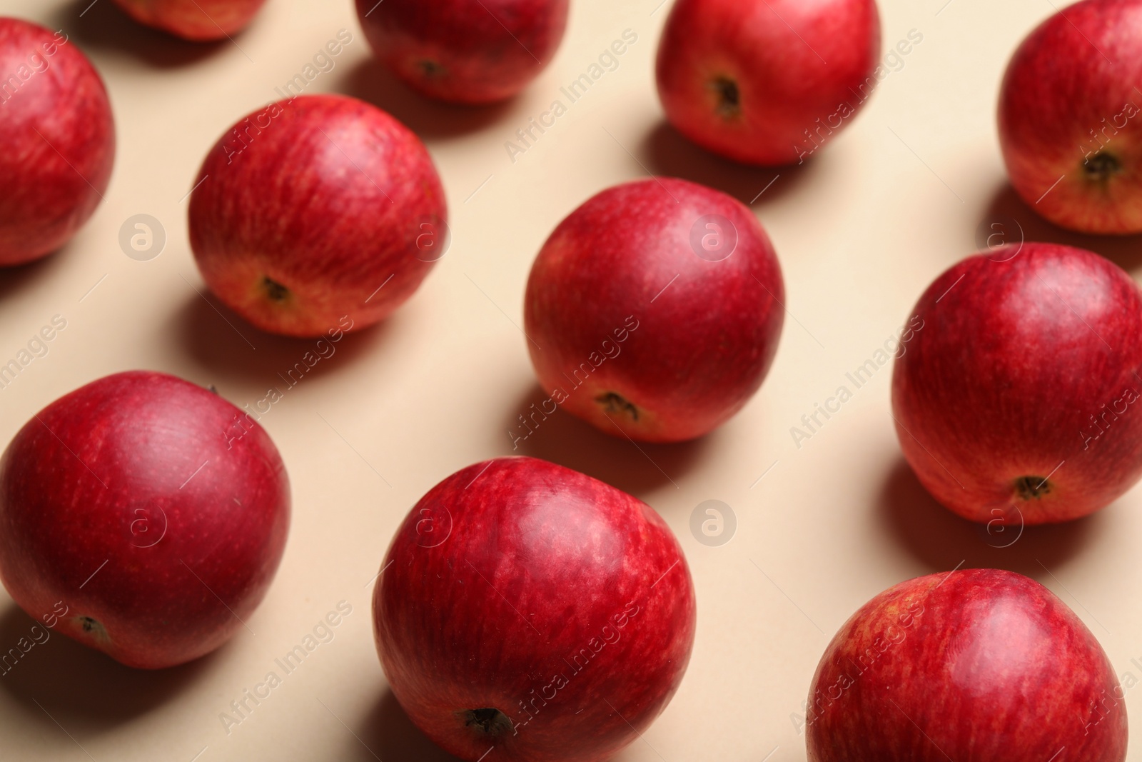 Photo of Fresh red apples on beige background, closeup