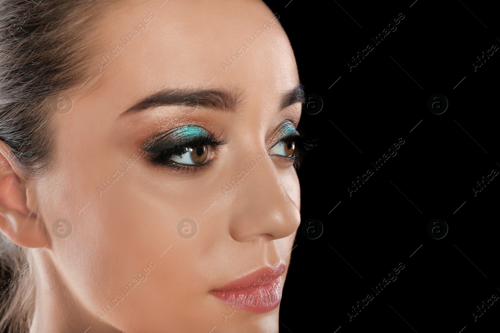 Photo of Young woman with eyelash extensions and beautiful makeup on black background. Space for text