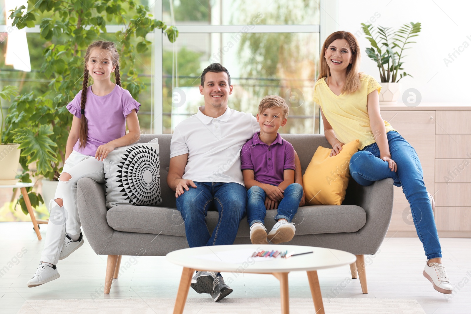 Photo of Happy family with cute children at home