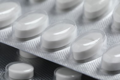 Photo of Pills in blisters as background, closeup view