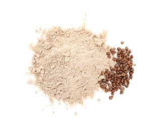 Photo of Pile of buckwheat flour and grains isolated on white, top view