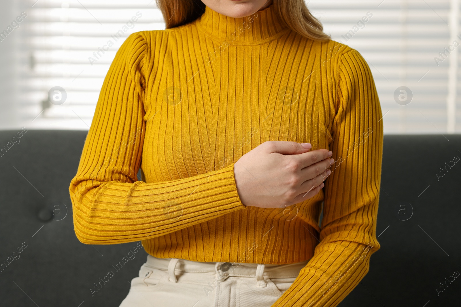 Photo of Mammology. Young woman doing breast self-examination at home, closeup