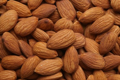 Photo of Delicious raw ripe almonds as background, closeup