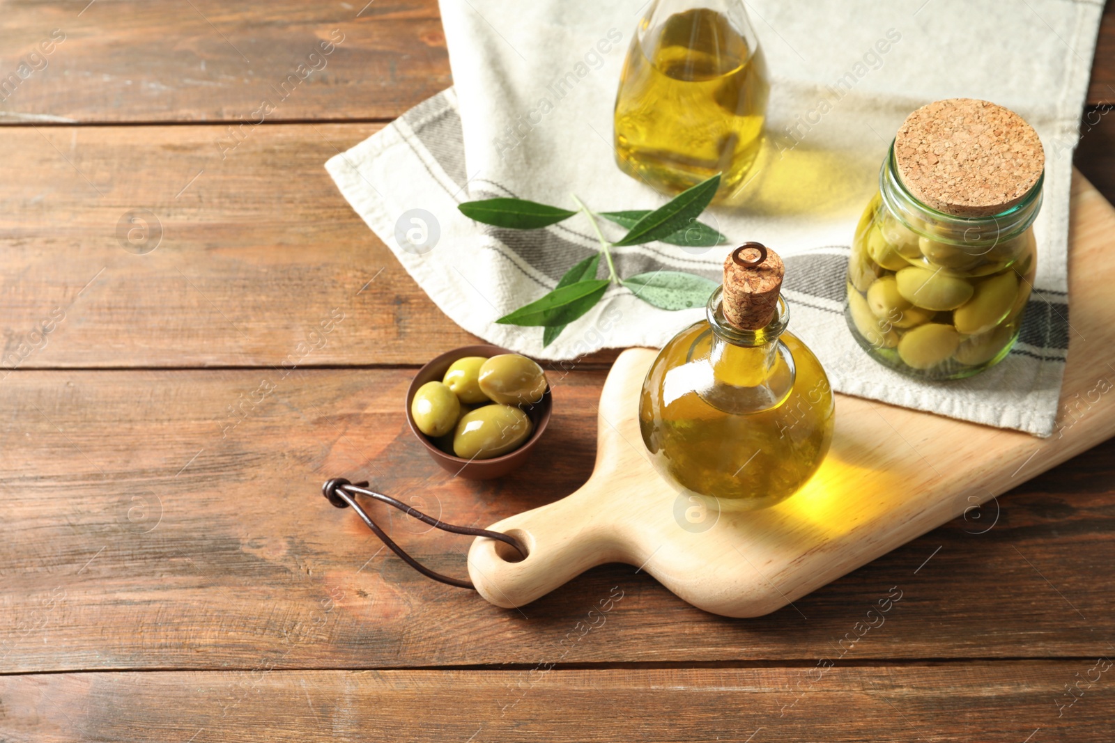 Photo of Composition with fresh olive oil on table