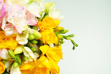 Photo of Beautiful colorful freesia bouquet on grey background, closeup