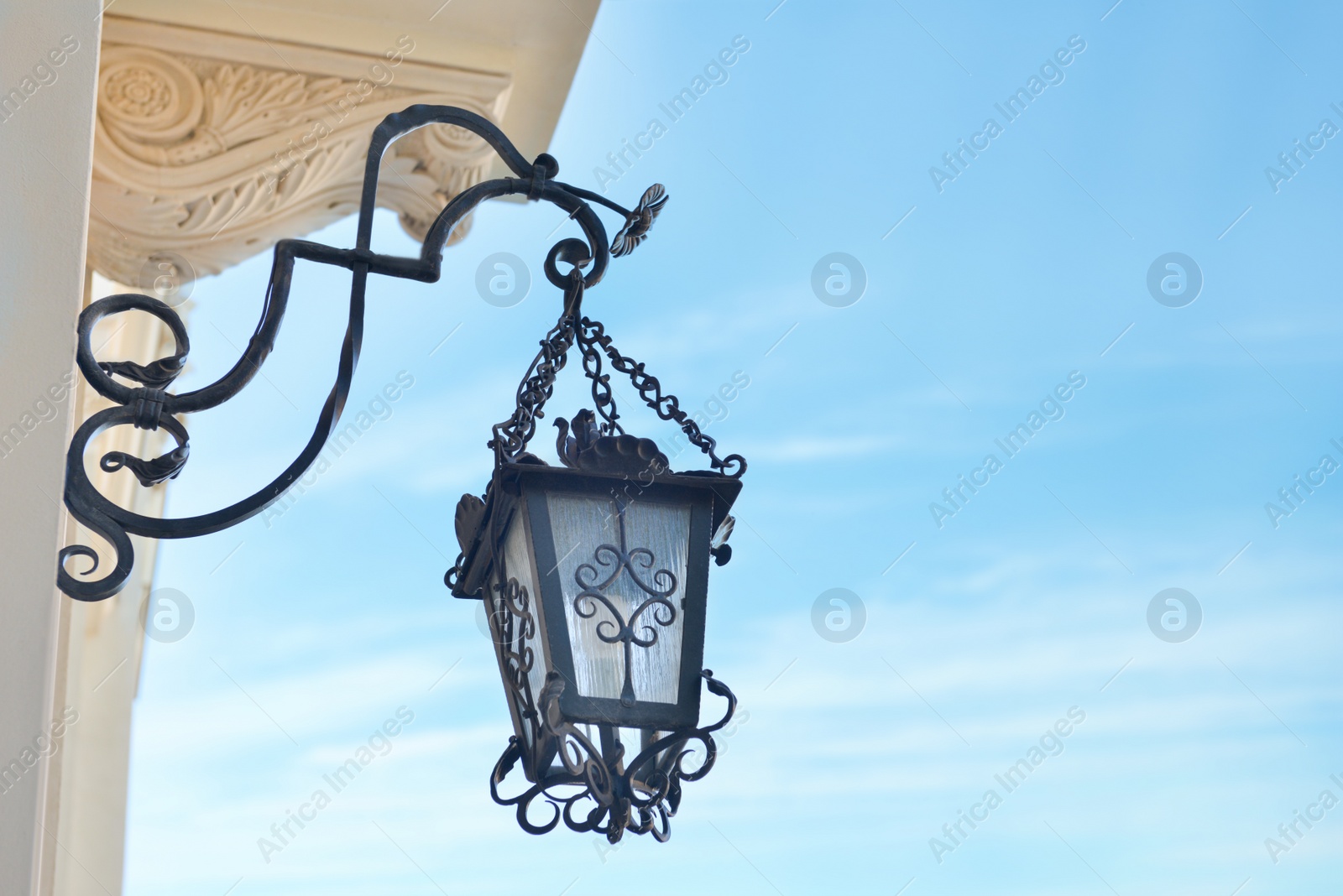 Photo of Beautiful vintage street lamp hanging on wall of building