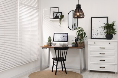 Cozy workspace with computer on wooden desk at home