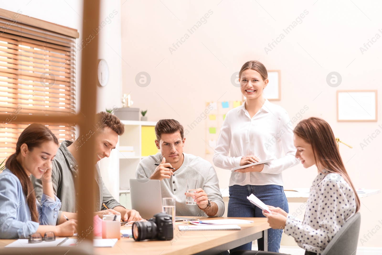 Photo of Team of professional journalists working in office