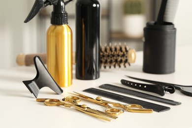 Photo of Hairdresser tools. Different scissors and combs on white table in salon