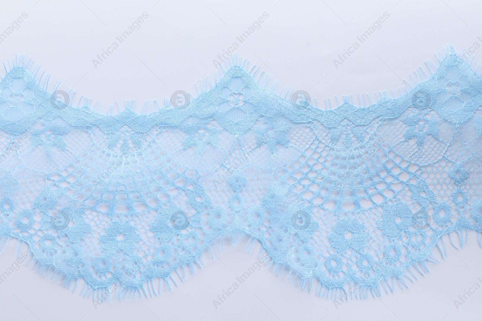 Photo of Beautiful lace on white background, top view