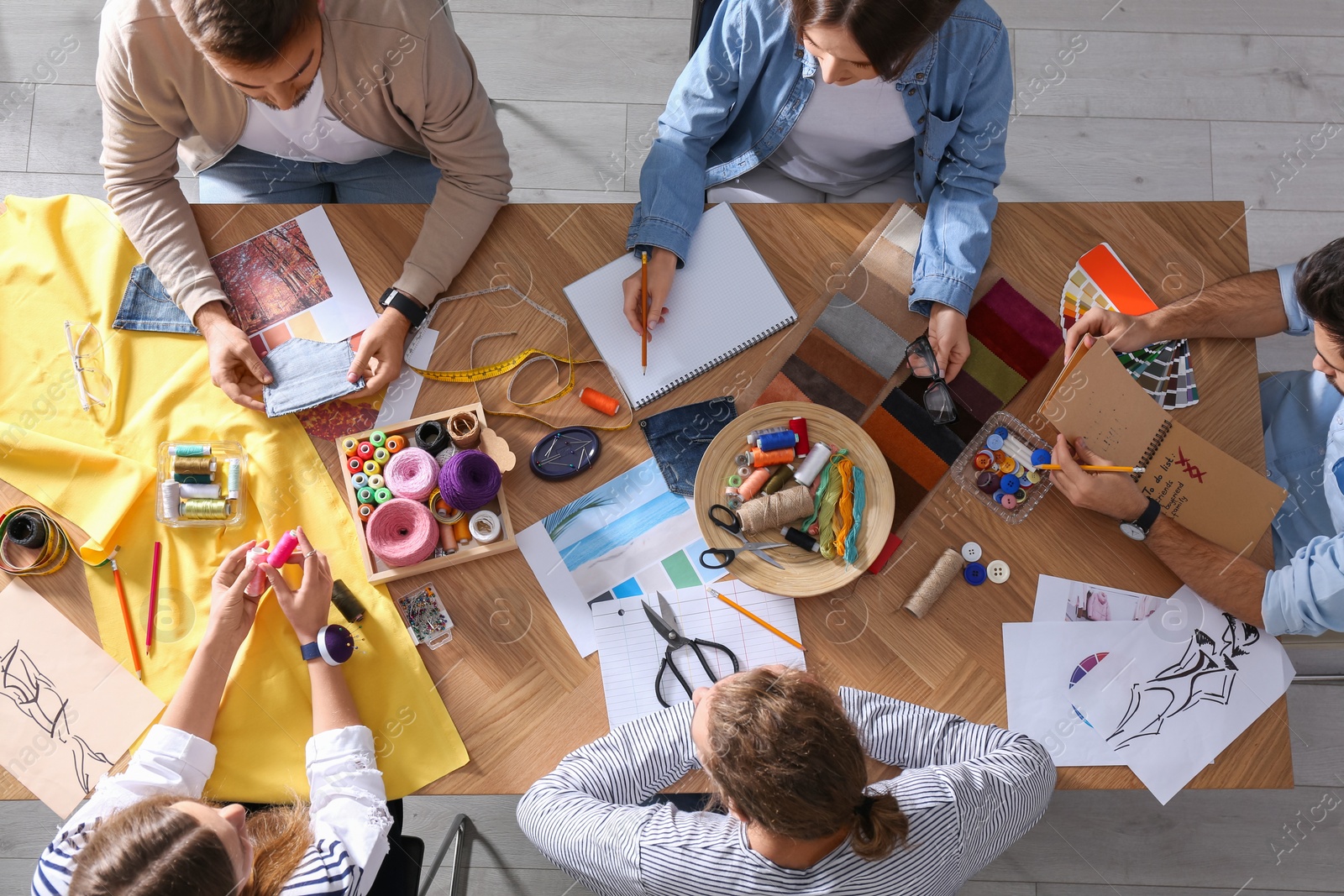 Photo of Fashion designer creating new clothes in studio, top view