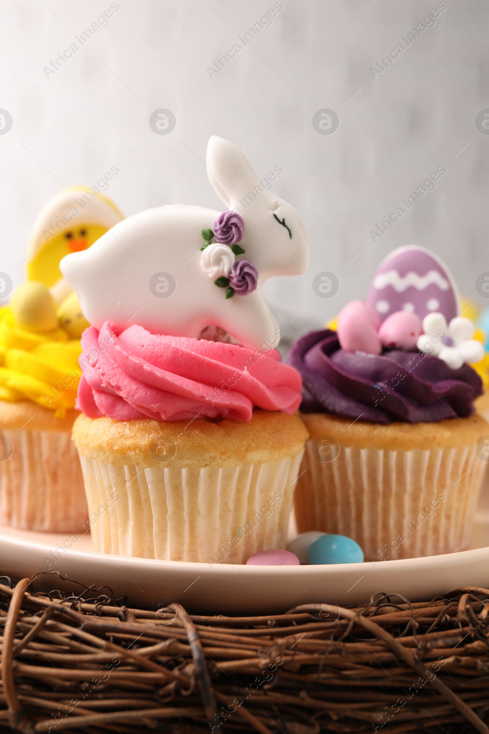 Photo of Tasty cupcakes with Easter decor on table