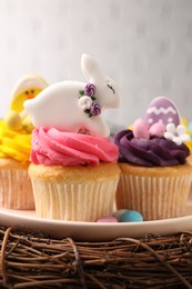 Tasty cupcakes with Easter decor on table