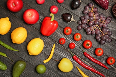 Rainbow collection of ripe fruits and vegetables on wooden background, top view