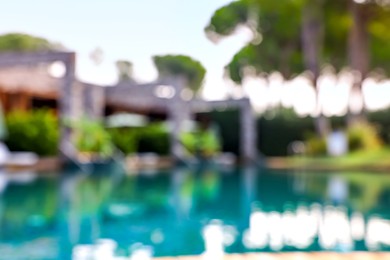 Blurred view of outdoor swimming pool at luxury resort