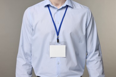 Photo of Man with empty badge on grey background, closeup